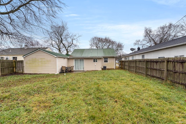 back of property featuring a lawn