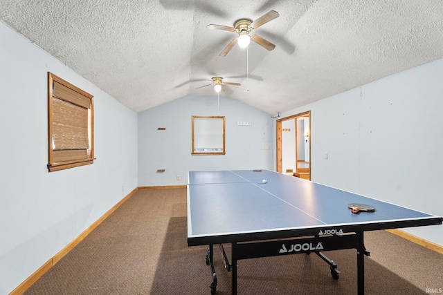 game room featuring a textured ceiling, carpet floors, vaulted ceiling, and ceiling fan