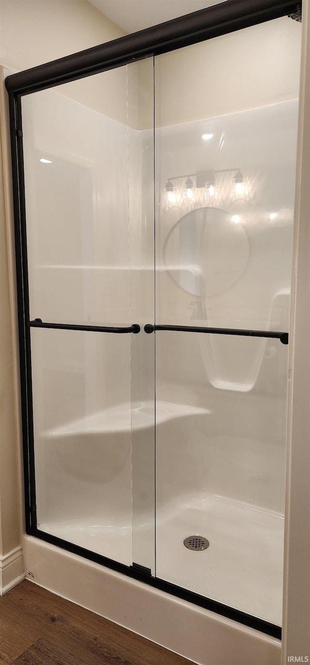 bathroom featuring a shower and hardwood / wood-style flooring