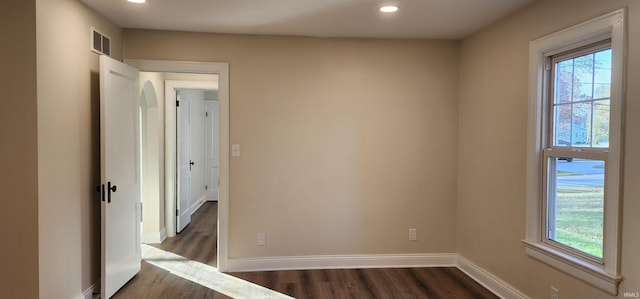 empty room featuring dark hardwood / wood-style flooring