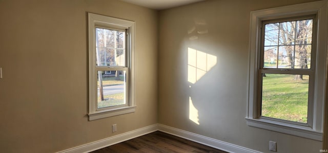 spare room with dark wood-type flooring