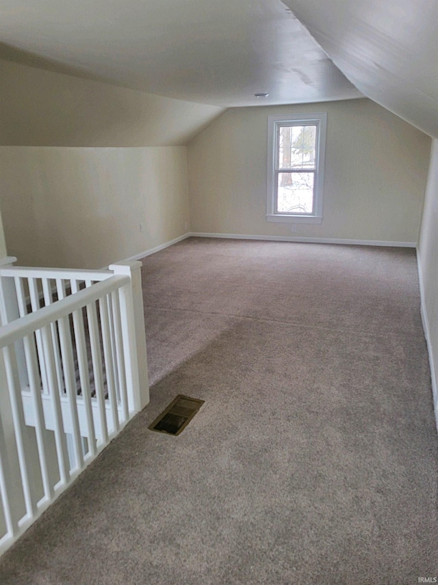 bonus room featuring carpet floors and vaulted ceiling