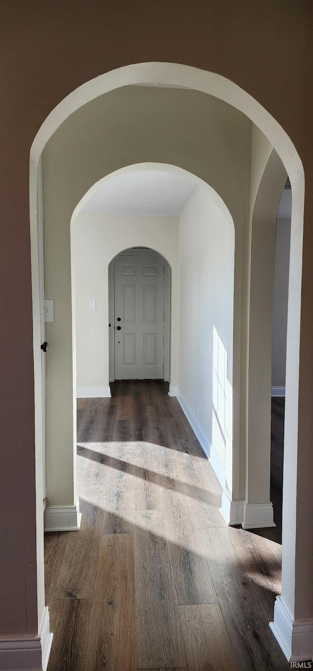 corridor with dark hardwood / wood-style floors