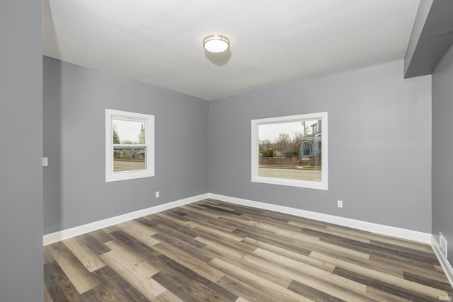 spare room with hardwood / wood-style floors and a healthy amount of sunlight