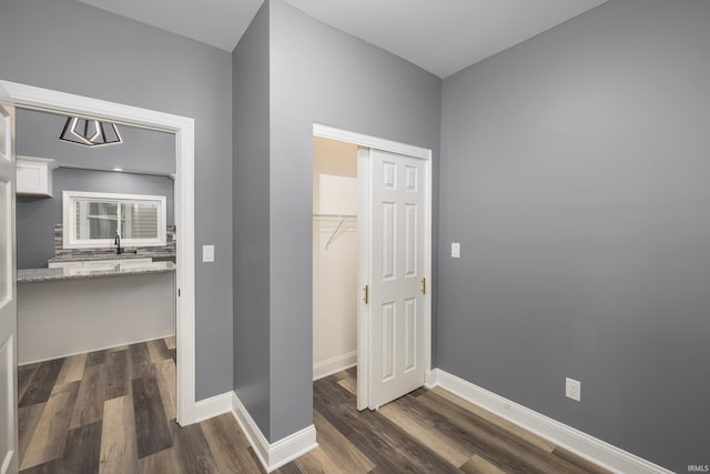 corridor featuring dark hardwood / wood-style flooring and sink