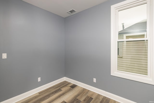 spare room featuring wood-type flooring