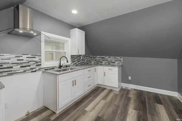 kitchen featuring dark wood-type flooring, sink, decorative backsplash, light stone countertops, and white cabinetry