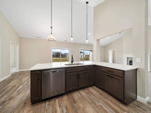 kitchen with dishwasher, dark brown cabinets, hardwood / wood-style flooring, and sink