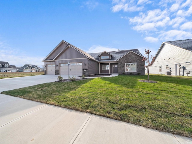 view of front of house with a garage, a front lawn, and central air condition unit