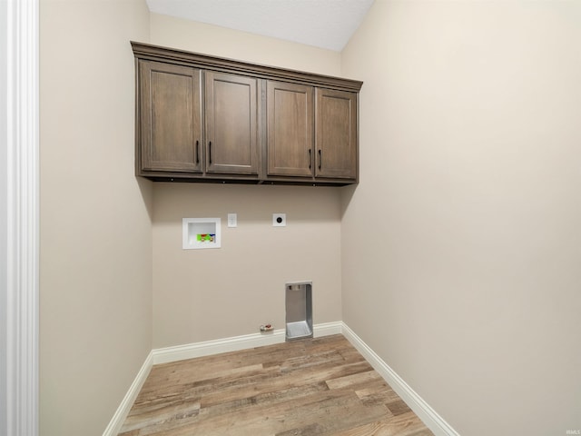 laundry room with cabinets, hookup for a gas dryer, hookup for a washing machine, light wood-type flooring, and hookup for an electric dryer