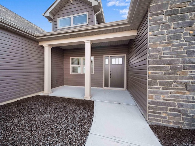 view of exterior entry with covered porch