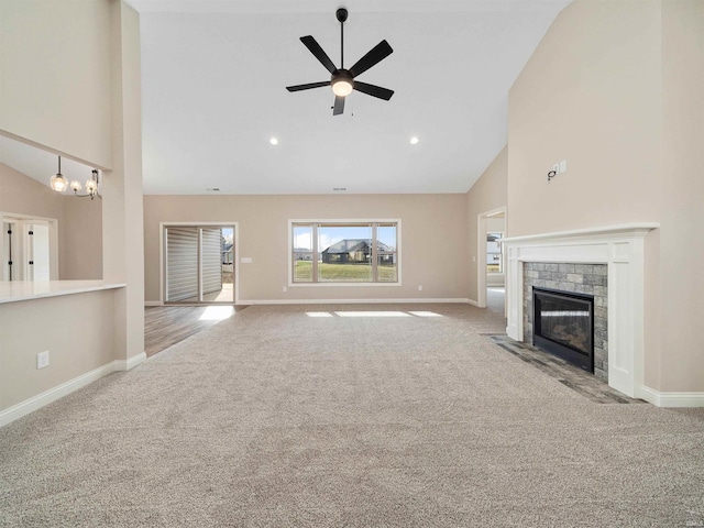 unfurnished living room with a stone fireplace, light carpet, high vaulted ceiling, and ceiling fan