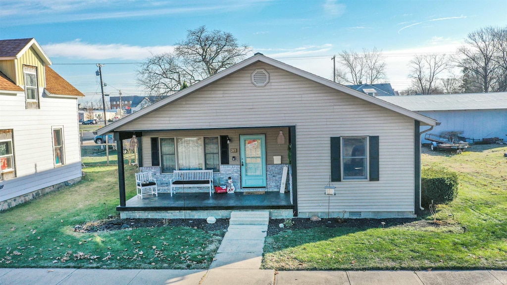 bungalow with a front yard and a porch