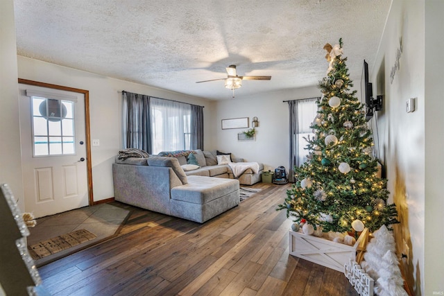 living room featuring ceiling fan, hardwood / wood-style floors, a healthy amount of sunlight, and a textured ceiling