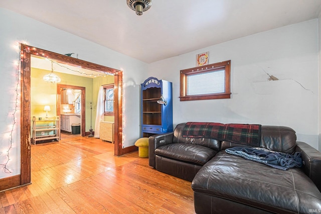 living room featuring hardwood / wood-style floors and an inviting chandelier