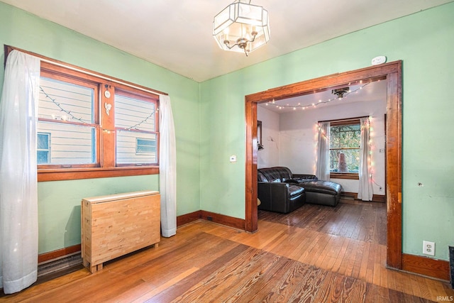 interior space featuring hardwood / wood-style floors and a notable chandelier