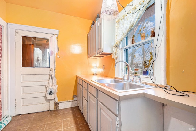 kitchen featuring light tile patterned floors and sink