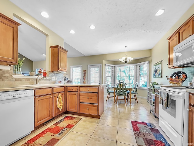 kitchen featuring white appliances, tasteful backsplash, and a healthy amount of sunlight