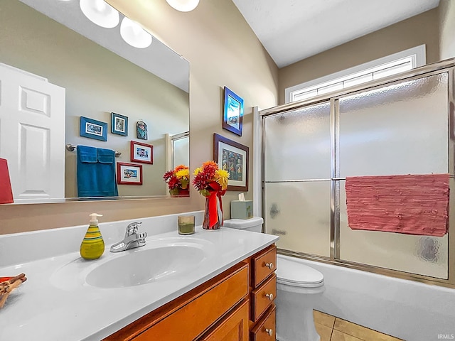 full bathroom with tile patterned floors, vanity, toilet, and combined bath / shower with glass door