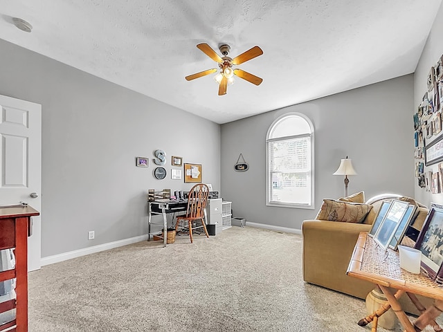 office with ceiling fan and a textured ceiling