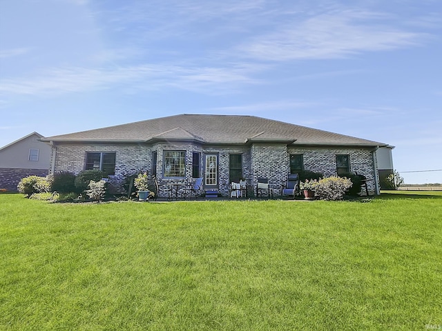 back of house with a lawn