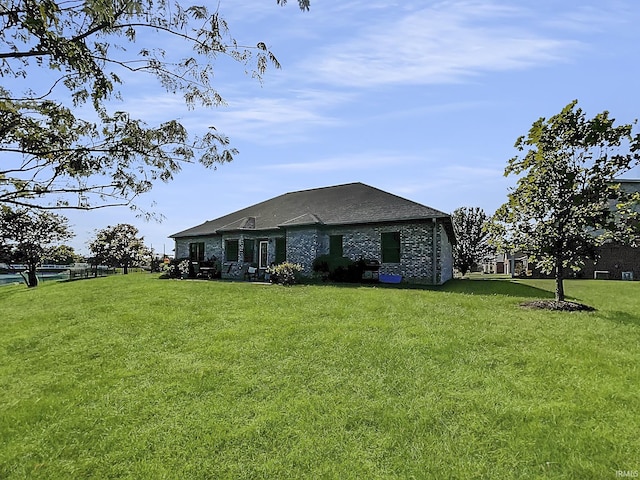 rear view of house featuring a yard