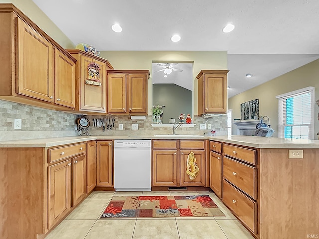 kitchen with kitchen peninsula, ceiling fan, sink, dishwasher, and lofted ceiling