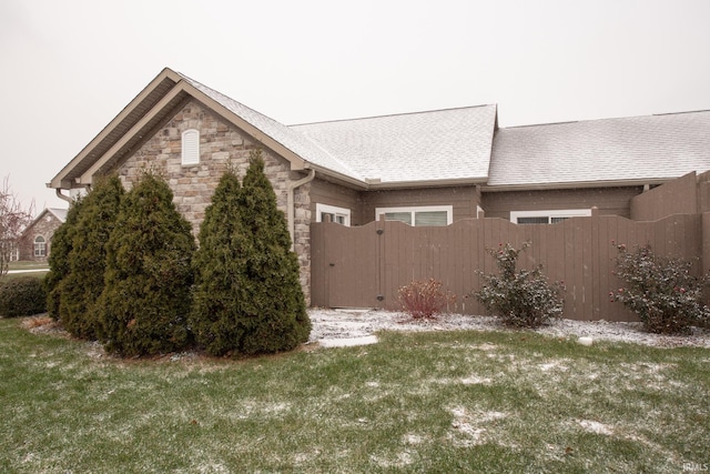 view of side of home featuring a yard