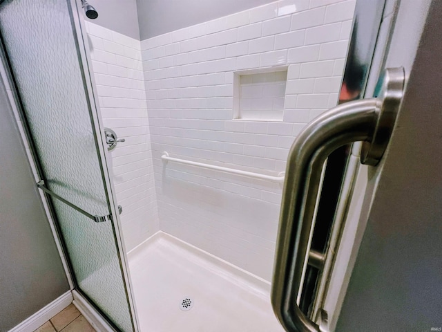 bathroom featuring tile patterned floors and an enclosed shower