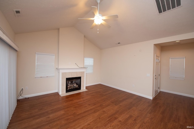 unfurnished living room featuring ceiling fan, dark wood-type flooring, lofted ceiling, and a fireplace