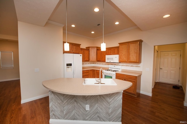 kitchen with sink, white appliances, hanging light fixtures, a kitchen island with sink, and ornamental molding