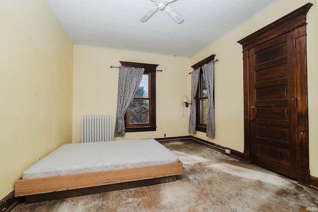 carpeted bedroom featuring radiator and ceiling fan