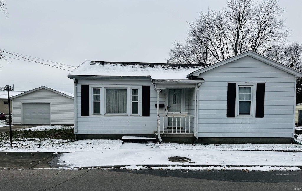 view of front facade featuring an outbuilding and a garage