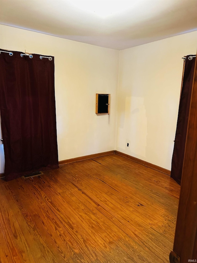 unfurnished room with hardwood / wood-style floors