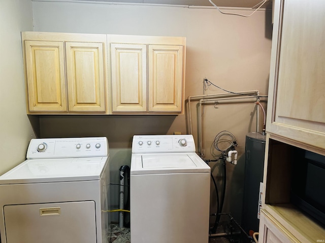 laundry room with cabinets and washer and clothes dryer