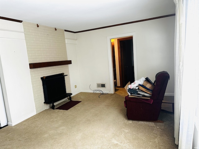 sitting room featuring carpet floors, a brick fireplace, and crown molding