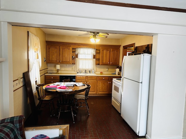 kitchen with ceiling fan, sink, and white appliances