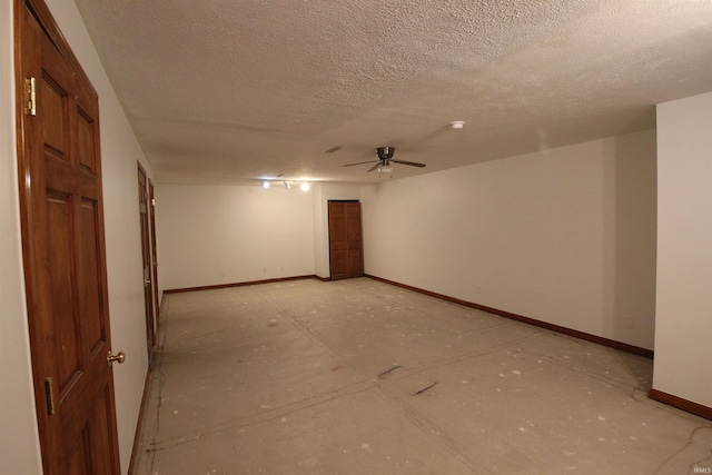 unfurnished room featuring a ceiling fan, baseboards, and a textured ceiling