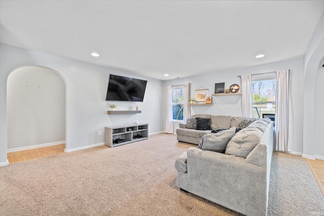 carpeted living room with a healthy amount of sunlight