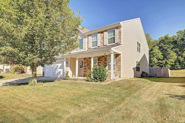 view of front of property with a front yard, a porch, and a garage