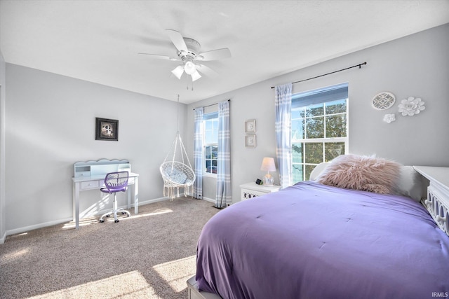 carpeted bedroom with multiple windows and ceiling fan