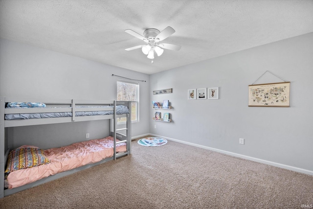 bedroom featuring a textured ceiling, carpet floors, and ceiling fan