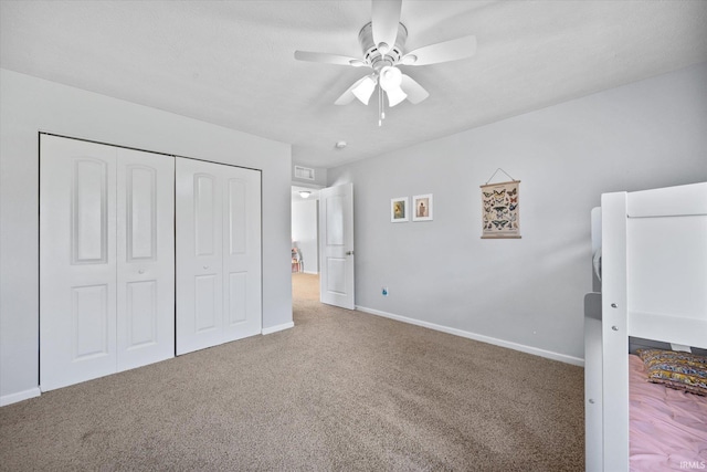 unfurnished bedroom with carpet flooring, a closet, and ceiling fan