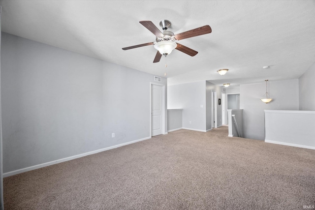 empty room featuring carpet and a textured ceiling