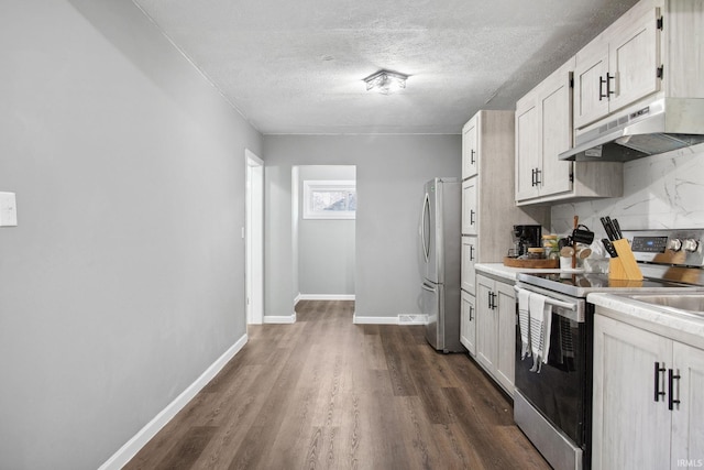 kitchen with white cabinetry, stainless steel appliances, tasteful backsplash, dark hardwood / wood-style floors, and a textured ceiling