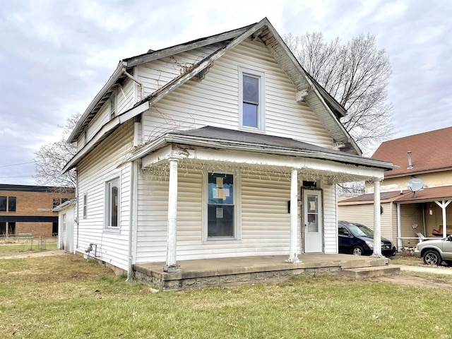 bungalow-style house featuring a porch and a front lawn