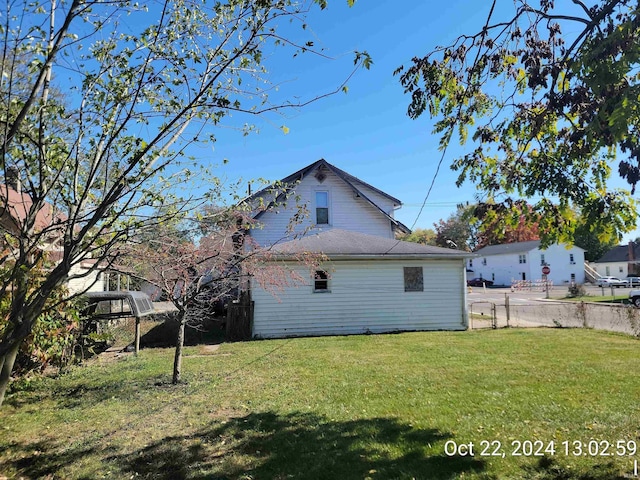 view of side of home featuring a lawn