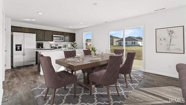 dining area with sink and dark hardwood / wood-style floors