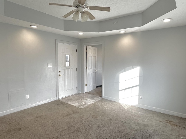 carpeted foyer entrance with ceiling fan and a textured ceiling