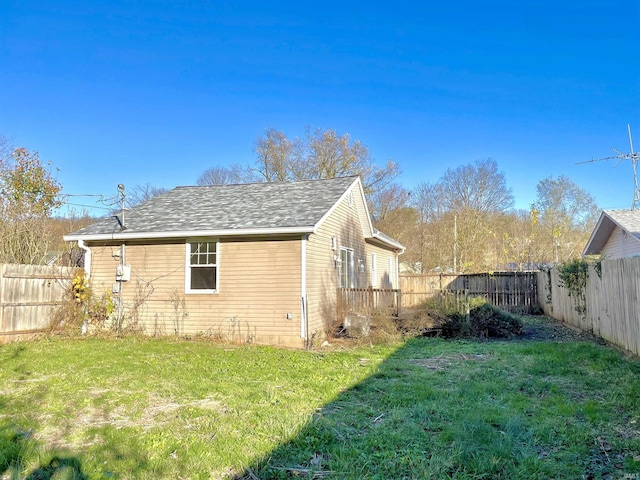 view of side of home featuring a lawn